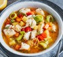 Bowl of fish soup with vegetables