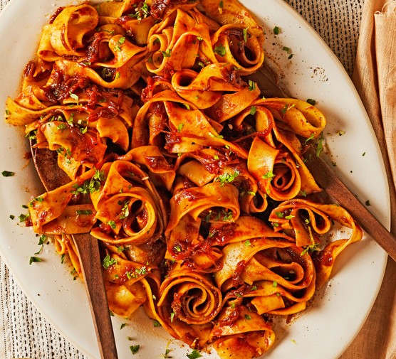 Caramelised red onion & anchovy pasta with gremolata served on a platter