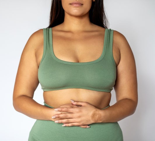 Midsection shot of a woman in underwear on white background.