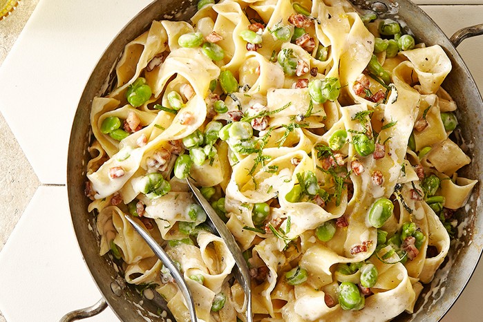 A wok serving broad bean pasta with bacon, cream & mint