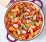 Quick vegetarian recipes Caponata pasta in pan, garnished with basil and parmesan