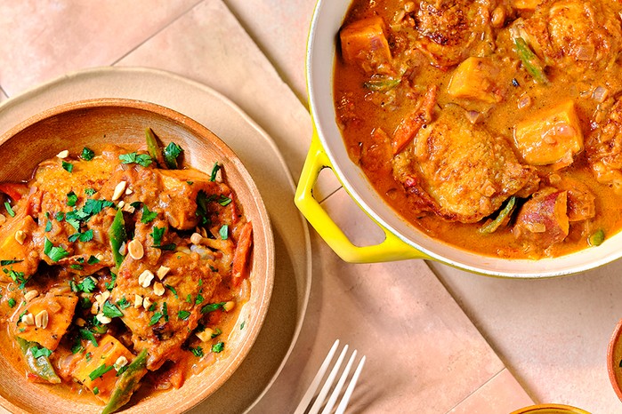 A casserole dish with chicken, sweet potato & peanut stew