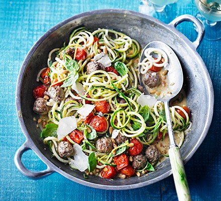 Courgetti with summer meatballs in a metal pan with a serving spoon