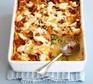 Creamy courgette lasagne Courgette lasagne in a baking dish with a spoon