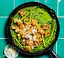 Crispy gnocchi in a frying pan with cavolo nero pesto, asparagus & peas