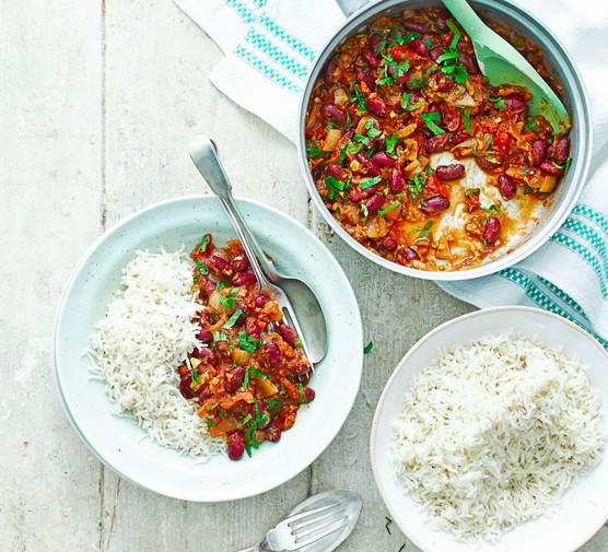 Kidney bean curry in a pot and on a plate with rice