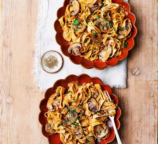 Two servings of mushroom stroganoff with tagliatelle