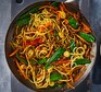 Pork noodle stir-fry in a wok