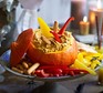 Pumpkin hummus served in a carved out pumpkin