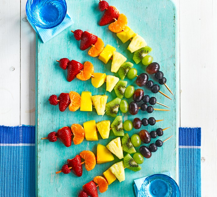 Rainbow fruit skewers on a platter
