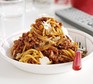 Big-batch bolognese Spaghetti bolognese in a white bowl with parmesan