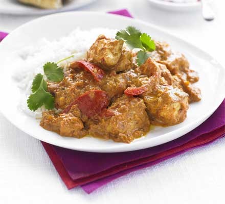 Chicken tikka masala with rice on a plate