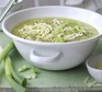 Healthy courgette, potato & cheddar soup in a white bowl topped with cheese