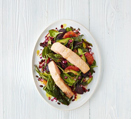 Two salmon fillets on a bed of salad