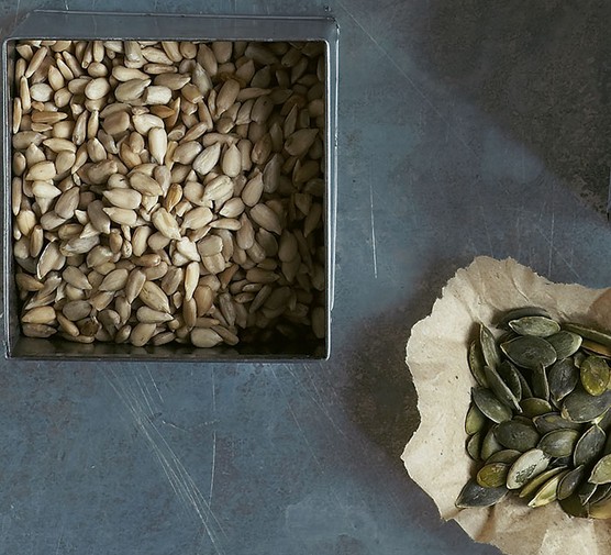 Magnesium-rich foods Bowls of sunflower and pumpkin seeds