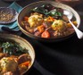 Two bowls of slow cooker beef stew with dumplings