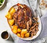 Slow cooker lamb shoulder served with roast potatoes