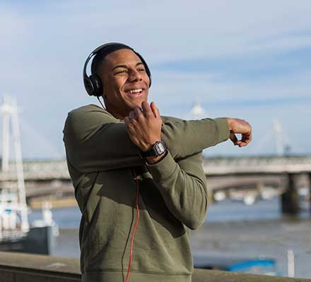 A man stretching his shoulders outdoors