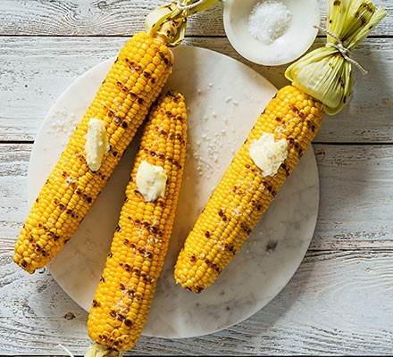 Three grilled corn on the cobs