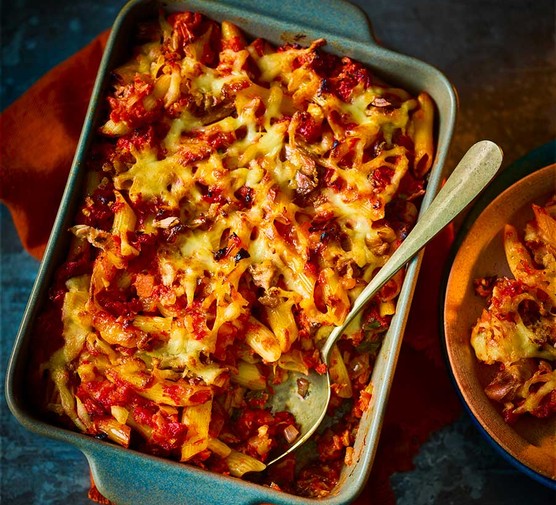 Air-fryer tuna pasta bake in a baking dish with a serving spoon