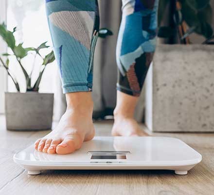 A person standing on weighing scales